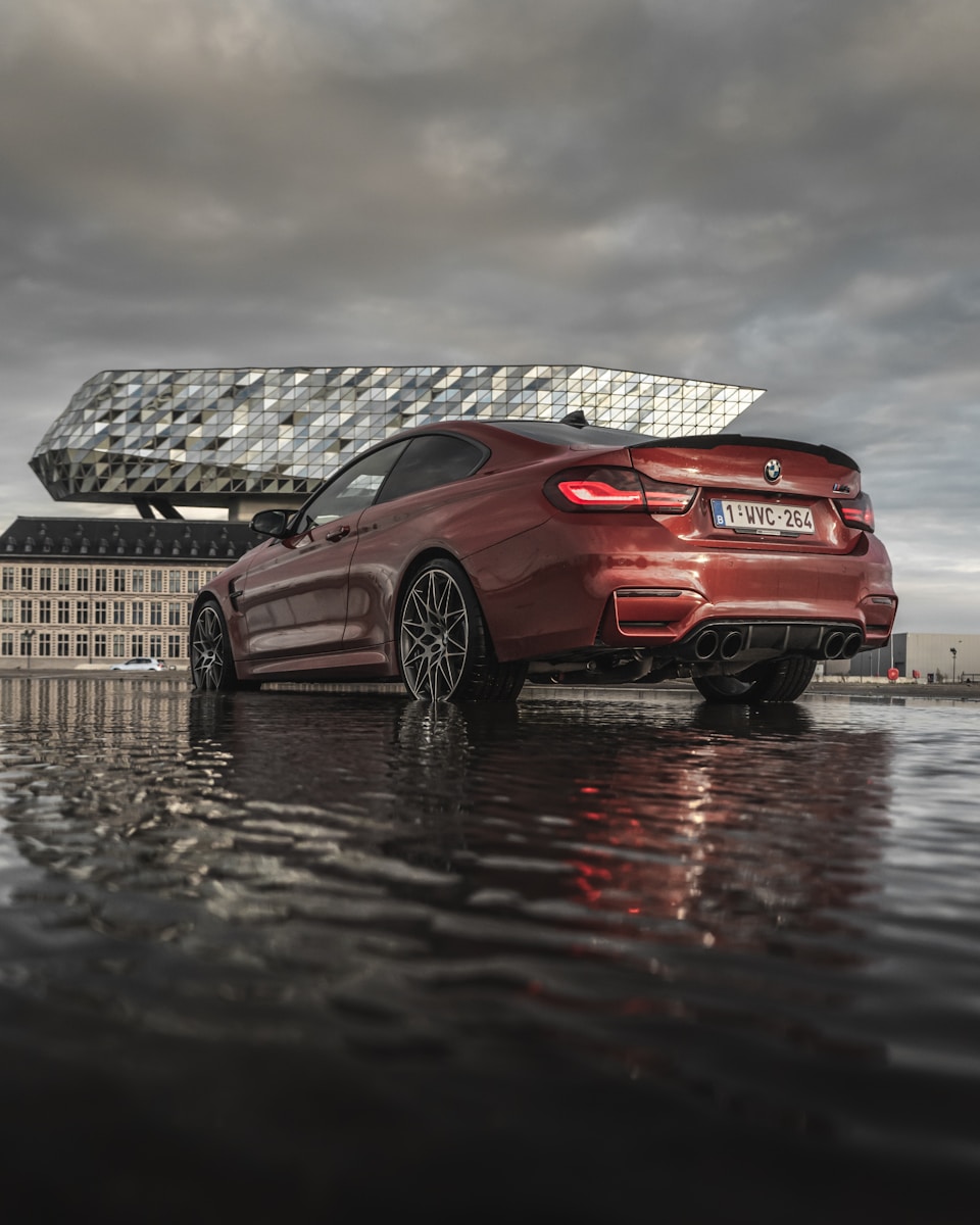 auto, flood red bmw m 3 coupe on dock during daytime